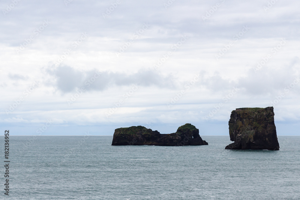rocks in ocean near Kirkjufjara beach in Iceland