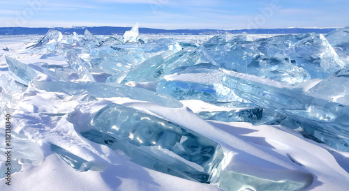 Frozen ice hummocks and ice cracks with blue sky during winter in Lake Baikal, Siberia, Russia