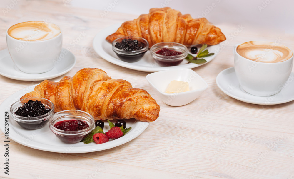 Close up of fresh croissants served with fresh coffee Close up of fresh croissants served with fresh coffee
