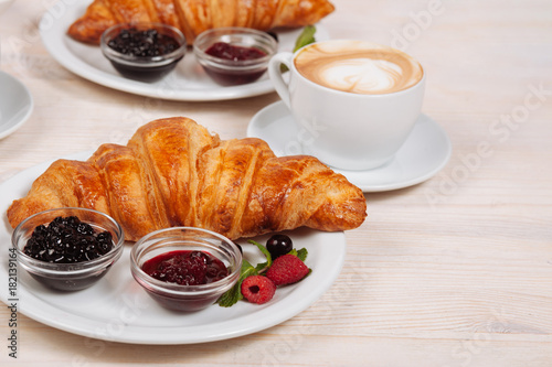 Close up of fresh croissants with coffee
