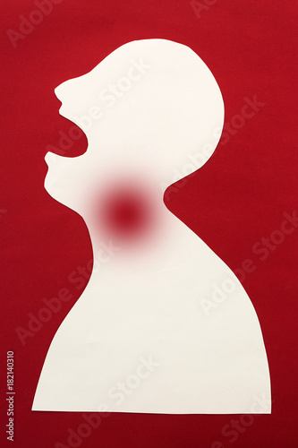 concept of human disease diagnosis and pain localization on silhouette - contour of abstract white man with opened mouth and severe pain in the throat, isolated on red background, top view, flat lay