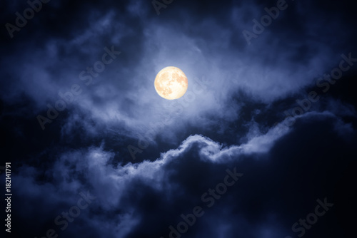 The moon on the dark sky among the clouds, natural abstract background