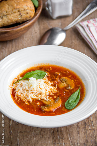 Italian soup with tomatoes, mushrooms, minced meat, cheese, vegetables