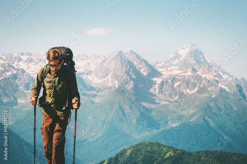 Man Traveler at mountains hiking with backpack Travel Lifestyle concept adventure outdoor rocky mountains landscape on background