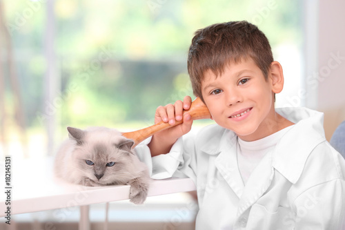 Cute little boy in doctor u...