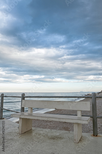 The viewpoint on the beach with bench of Marotta under a cloudy sky, Italy © luigimorbidelli