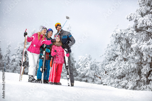 Happy woman with family making selfie in mountain