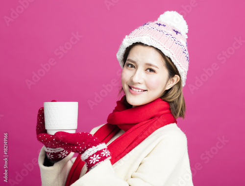 woman in warm sweater drinking a cup of hot tea. photo