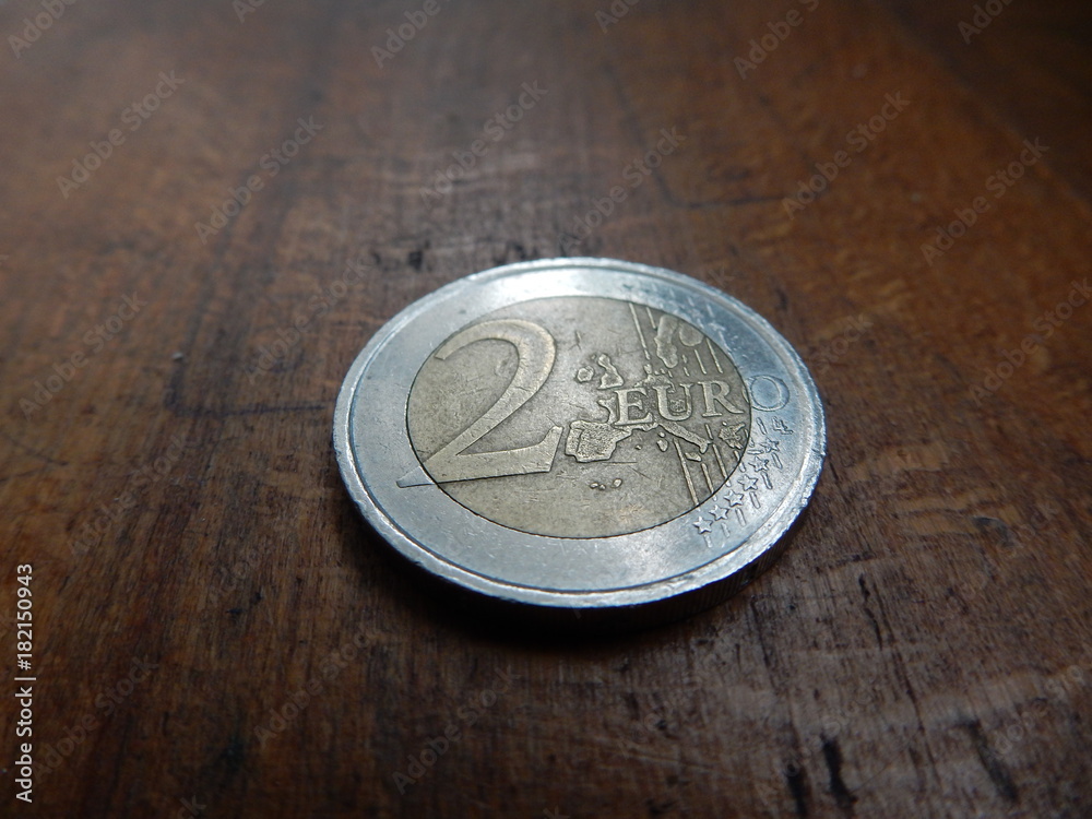 2 euro coin on wooden background 2 euro coin on wooden background