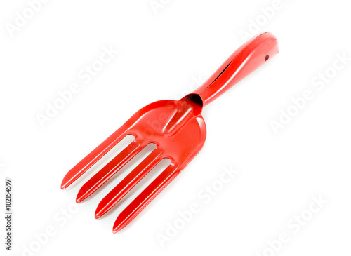 red garden fork on white background