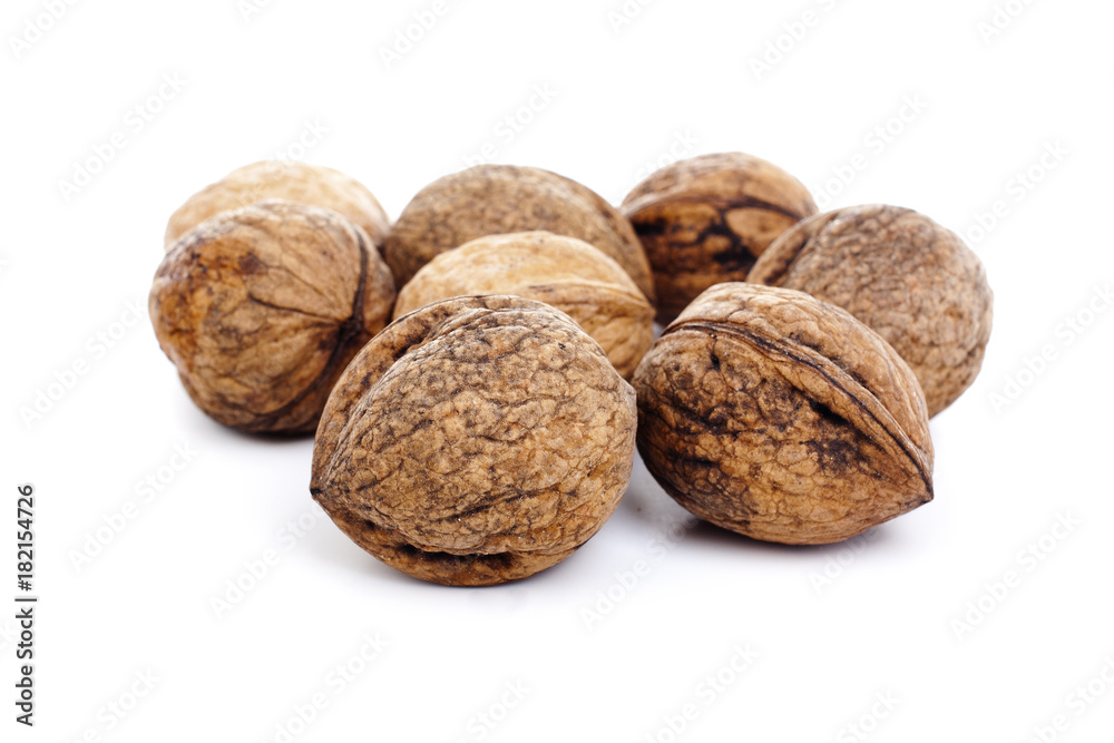 Walnuts on isolated white studio photo. Walnut with shell. Walnuts on isolated white studio photo. Walnut with shell.