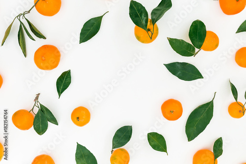 Frame made of fresh citrus and leaves on white background. Flat lay. Top view