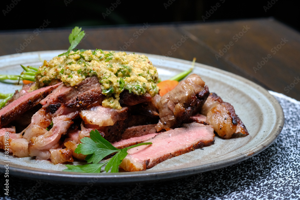 Close up Steak with Green Olive Pesto. (selective focus) Close up Steak with Green Olive Pesto. (selective focus)