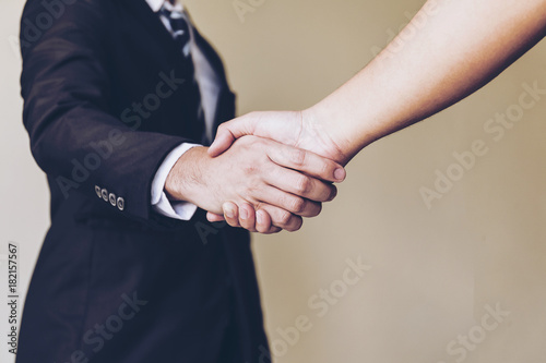 Trust your partner company. Business partnership meeting concept. Successful businessman and Investor or sales manager or Lawyer or Real estate broker agent and customer handshaking after good deal.