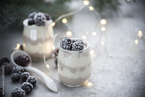 winter milk dessert with frozen blackberry 