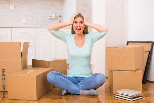 Woman screaming in panic because of too much things to do while moving into new home.