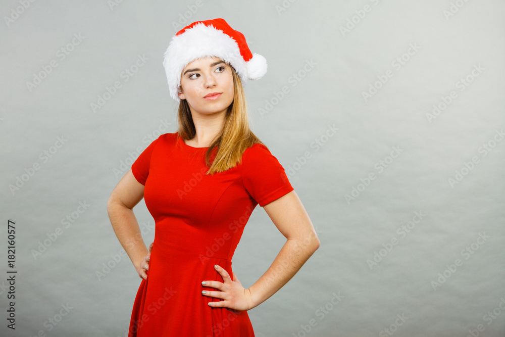 Obraz premium Thinking woman wearing Santa Claus helper costume