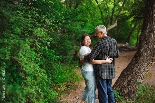 Senior couple walking together in a forest, close-up