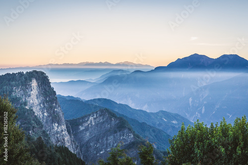 Photography Scenic view of mountain range covered by fog in morning before sunrise at Zhushan, Alishan Recreation Area of Taiwan