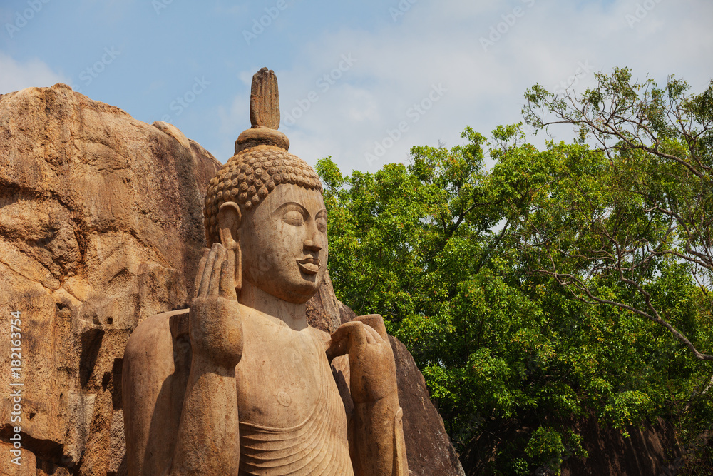 Avukana statue is a standing statue of the Buddha. Sri Lanka. Horizontal shot Avukana statue is a standing statue of the Buddha. Sri Lanka. Horizontal shot