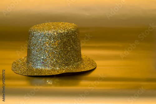New Year's Eve top hat on a gold background.