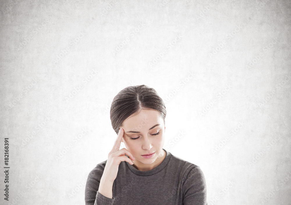 Stressed young woman in brown, concrete Stressed young woman in brown, concrete