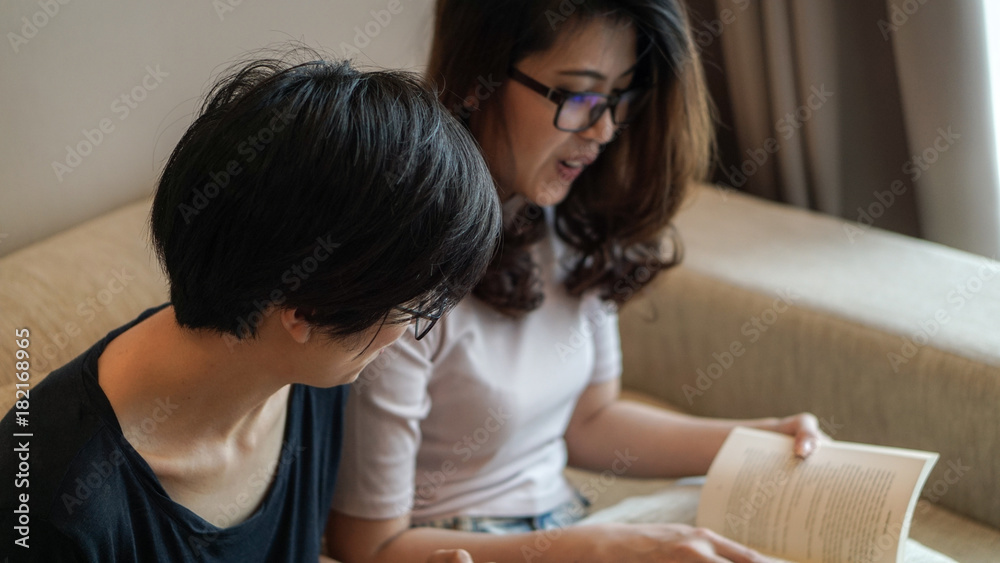 Two Asian woman friends reading books and discussion on hobby Two Asian woman friends reading books and discussion on hobby