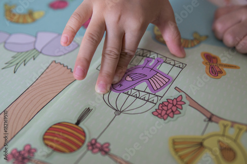 kid playing stickers