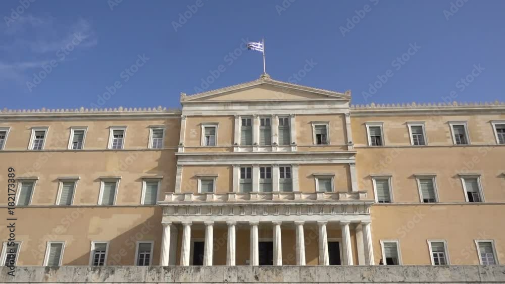 waving flag on the Greek parliament building in Athens, Greece