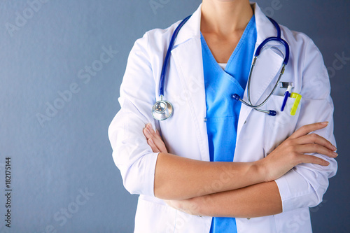 Portrait of young woman doctor with white coat standing in hospital