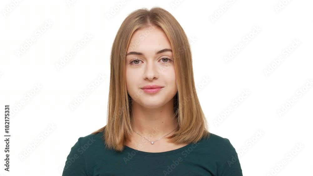 Portrait of lovely woman with golden straight hair posing at camera with kind relaxed look being isolated over white background in studio. Concept of emotions Portrait of lovely woman with golden straight hair posing at camera with kind relaxed look being isolated over white background in studio. Concept of emotions