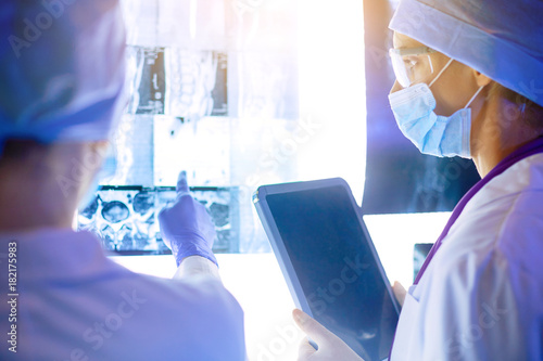 Two female women medical doctors looking at x-rays in a hospital