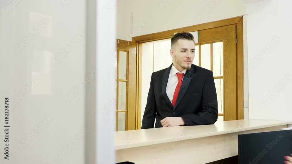 Businessman is getting a key from secretary while a blonde businesswoman is comming to the her Businessman is getting a key from secretary while a blonde businesswoman is comming to the her