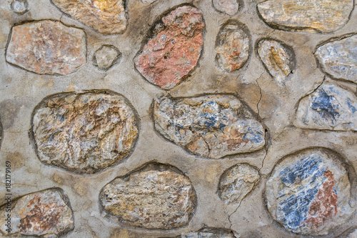 Multicolored stones in concrete. Background.