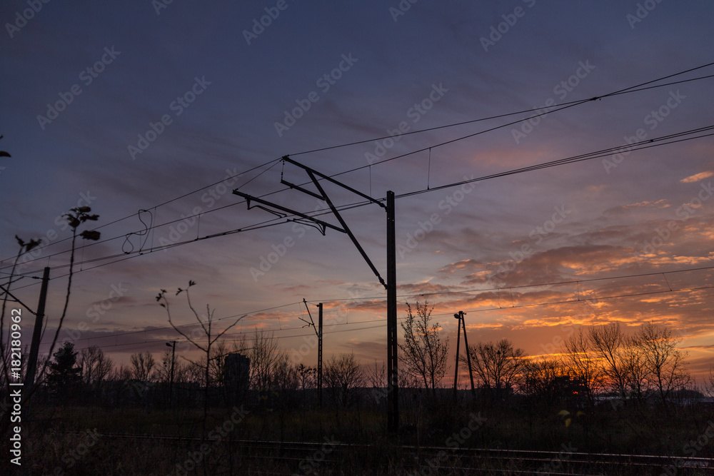  Electric traction pole against the sky with the setting sun