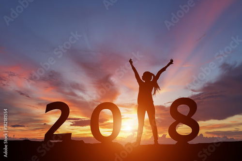 Silhouette of happy woman with New yeay 2018 concept in sunset background.