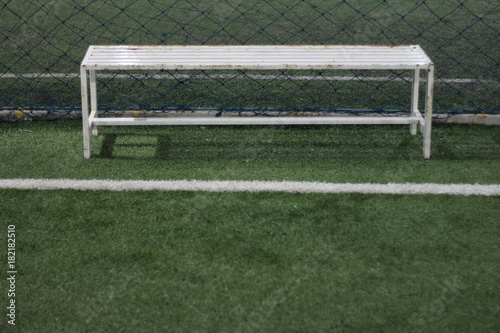 white bench,Long chair on the artificial grass football field