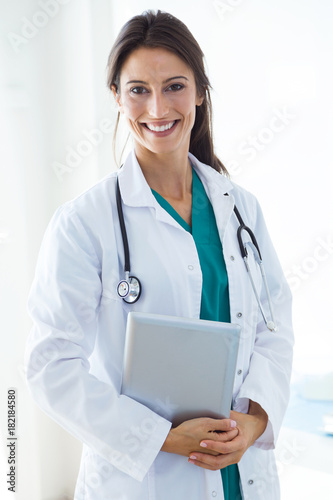 Beautiful young female doctor looking at camera in the office.