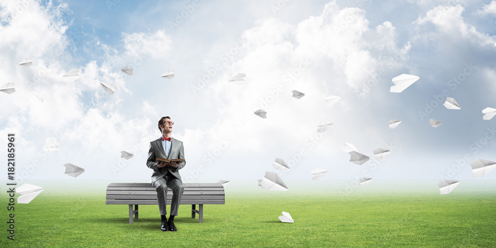 Young businessman or student studying the science and paper planes fly around Young businessman or student studying the science and paper planes fly around