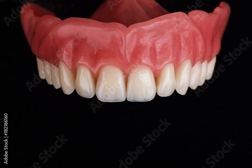 upper part of denture, removed on a black background