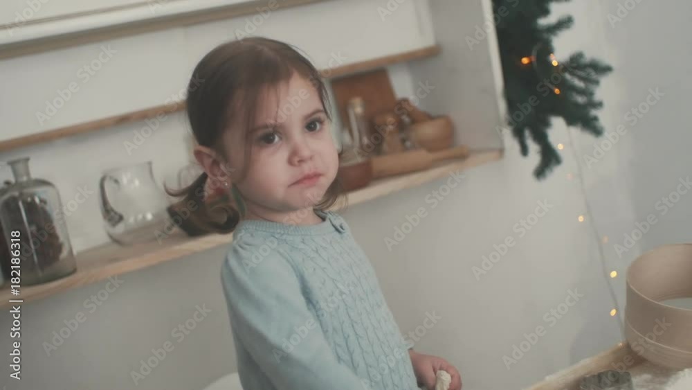 little girls make dough, bake cookies in the kitchen