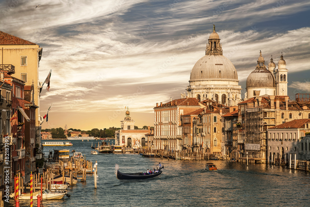 Grand Canal overlooking the Cathedral of Santa Maria della Salute and gondola with tourists, Venice, Italy