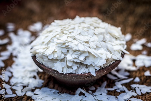 Oryza sativa,Puffed rice in a clay bowl on a gunny background. photo