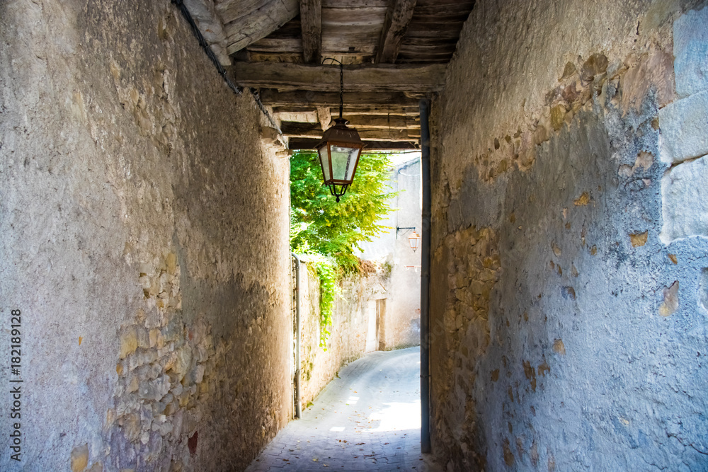 Fototapeta premium Passage in a narrow ancient street with wooden beams and a lantern.