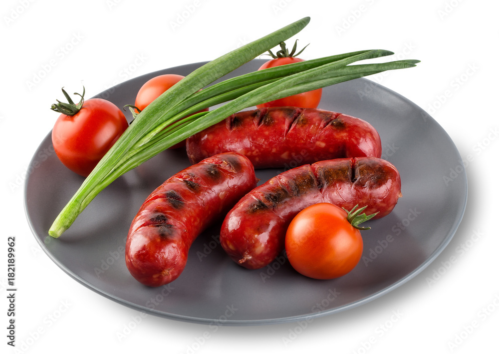 Attractive sausages with tomatoes and onions on gray plate Attractive sausages with tomatoes and onions on gray plate