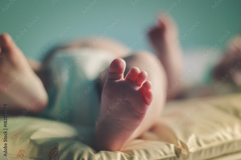 Naklejka premium Baby foot close up with blue background