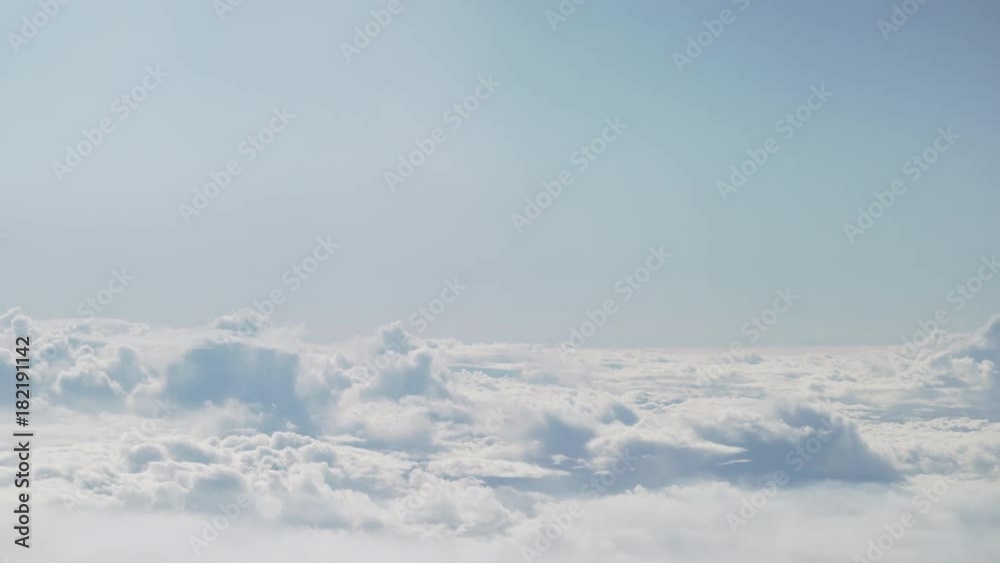 aerial shot from plane flying above the clouds in daytime aerial shot from plane flying above the clouds in daytime