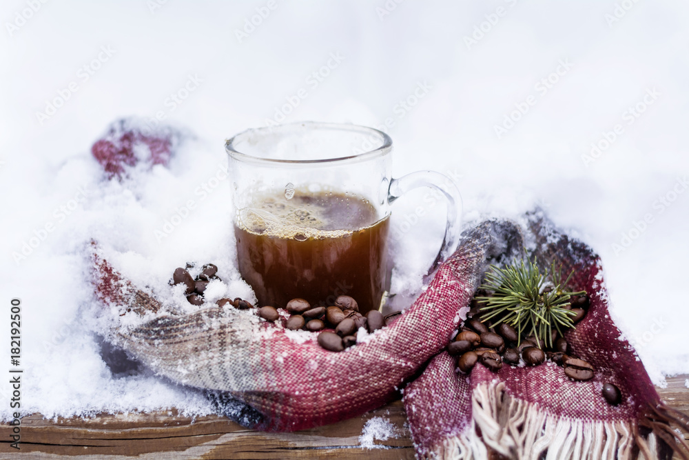 Cup of Coffee Wrapped in a Knitted Scarf on the Snow Cup of Coffee Wrapped in a Knitted Scarf on the Snow