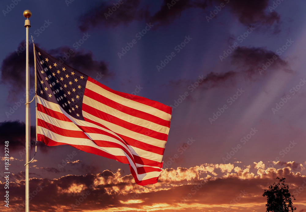 Obraz premium American flag on flagpole waving in the wind American flag in front of bright sky
