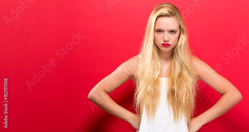Unhappy young woman on a solid background